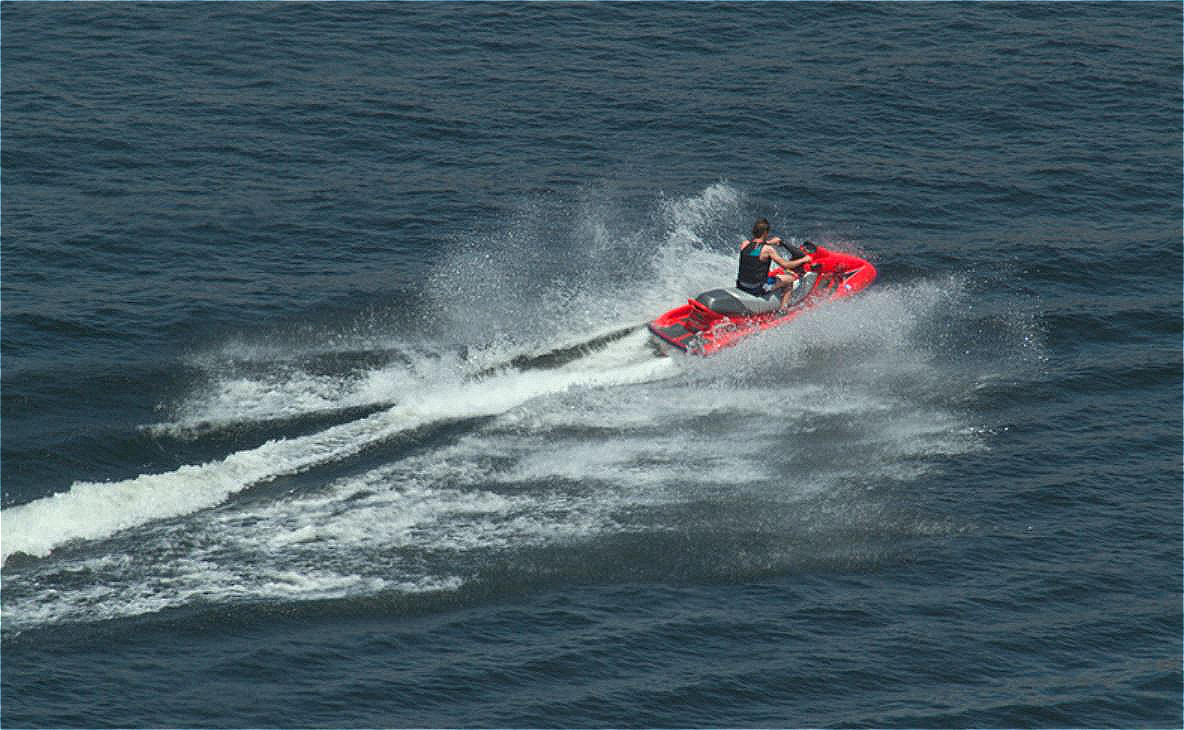 Person on jet ski speeding across water